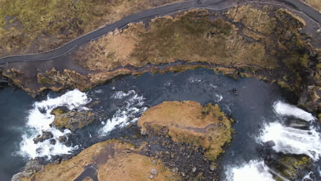 aerial top shot of the waterfalls in front of kirkjufell, iceland