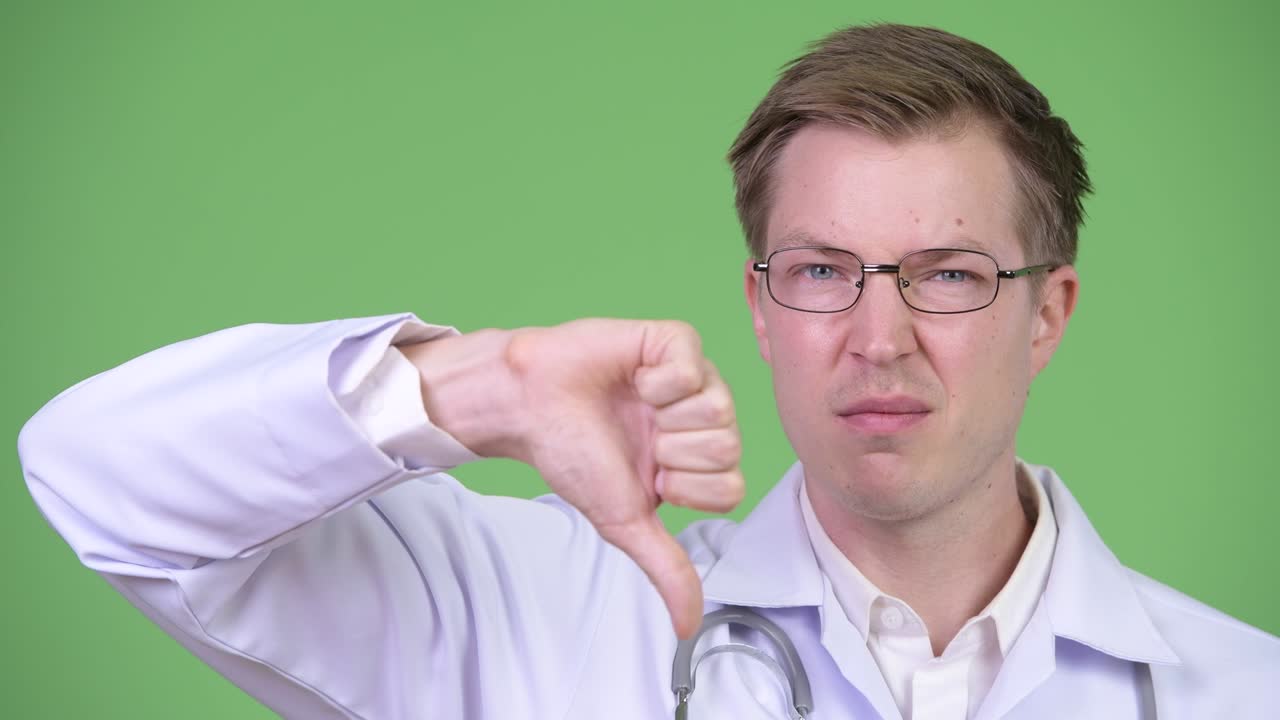 Close-Up Of Man Doctor Making Thumb Down Gesture
