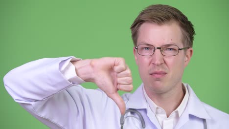close-up of man doctor making thumb down gesture
