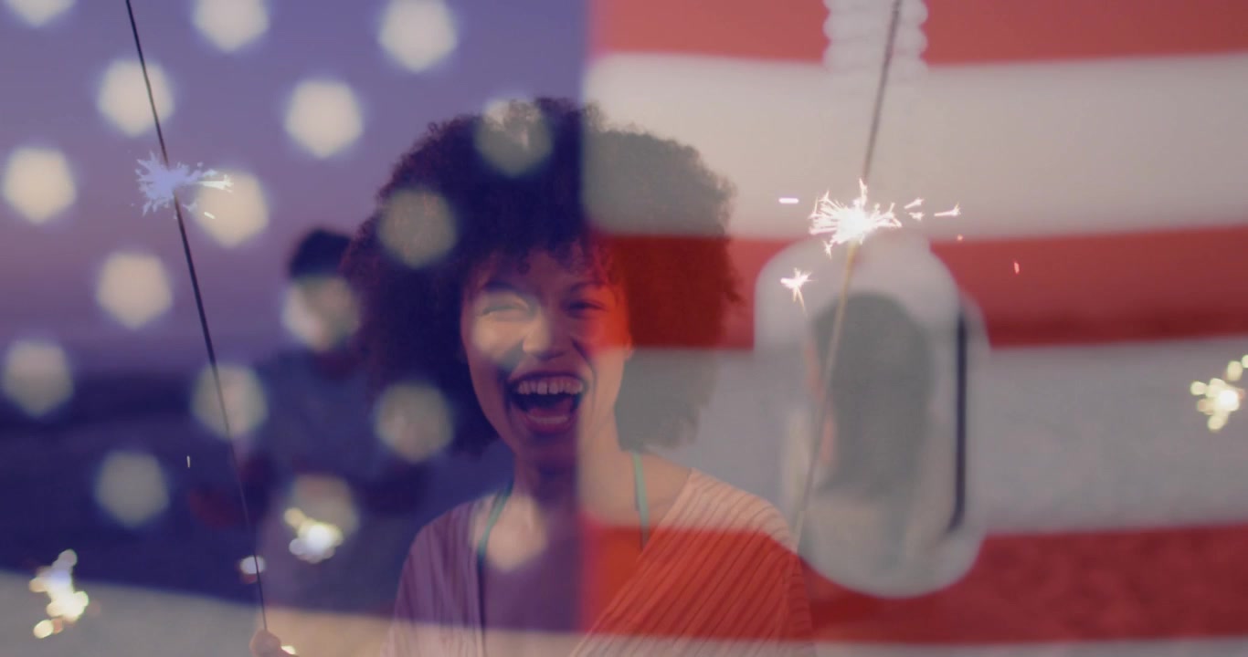 Double Exposure of American Flag and People Celebrating with Sparklers