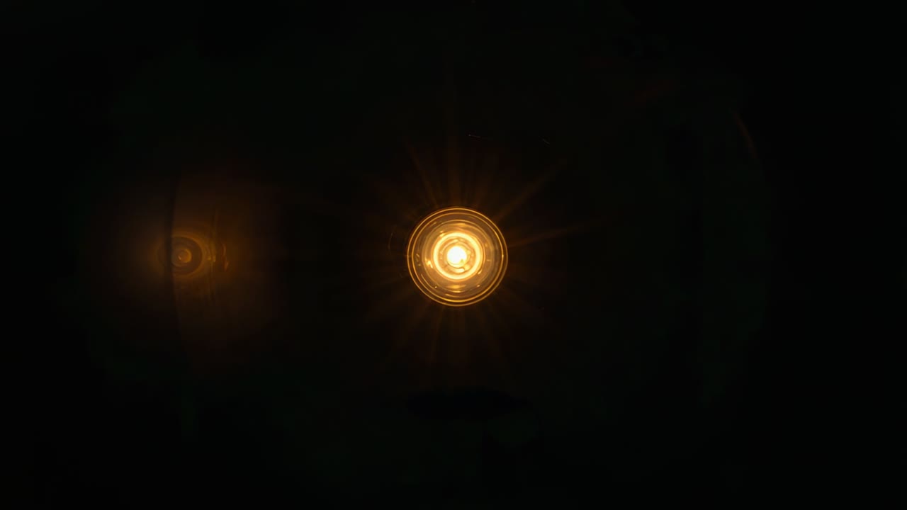 Bright bulb starting shot, ceiling light glowing, rings and ghost reflection aiding lighting design