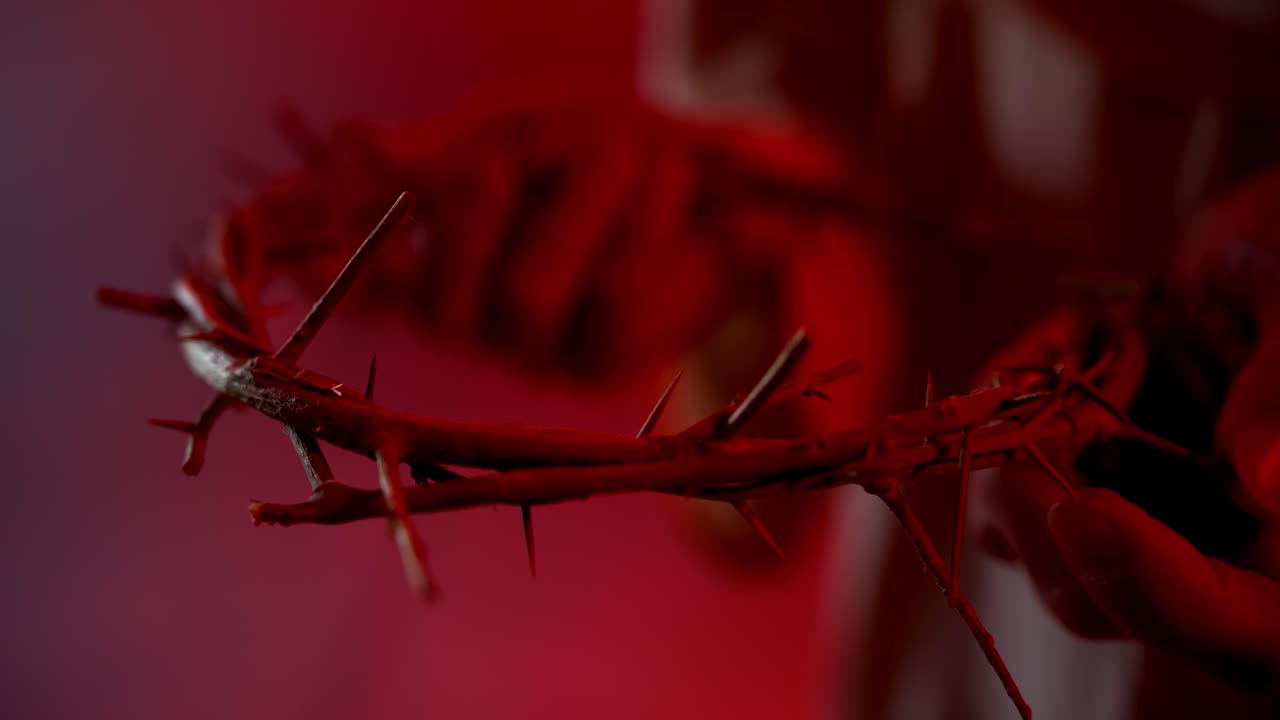 Jesus Christ closeup holding a crown of thorns for Christianity, Easter visual, bible scene or temptation, prayer, worship visual.