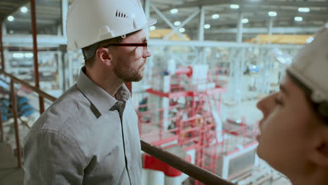 factory supervisor discussing manufacturing process with female worker