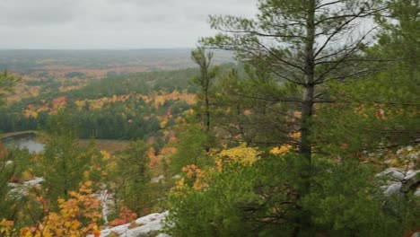 man with film camera takes photo at lookout, slow motion handheld pan