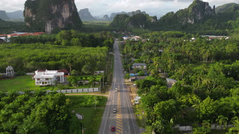 Aerial-flying-over-road-in-Krabi-province-with-beautiful-limestone-cliffs