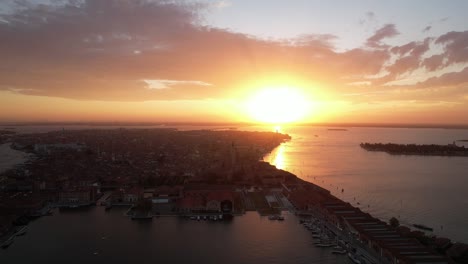 Aerial-View-Above-Venice-Italy,-Island-City,-Venetian-Lagoon,-Golden-Sunset,-Yellow-Horizon-over-Town-of-Canals,-Travel-and-Tourism-Destination,-European-Summer