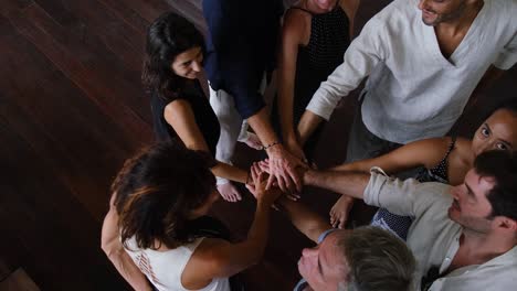 diverse group of multiethnic young people with hands together. teamwork, race, ethnicity, people and support concept