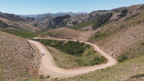 Rural-dirt-road-in-the-mountains,-a-pickup-truck-is-moving