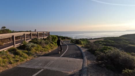 cyclist riding on a scenic coastal path