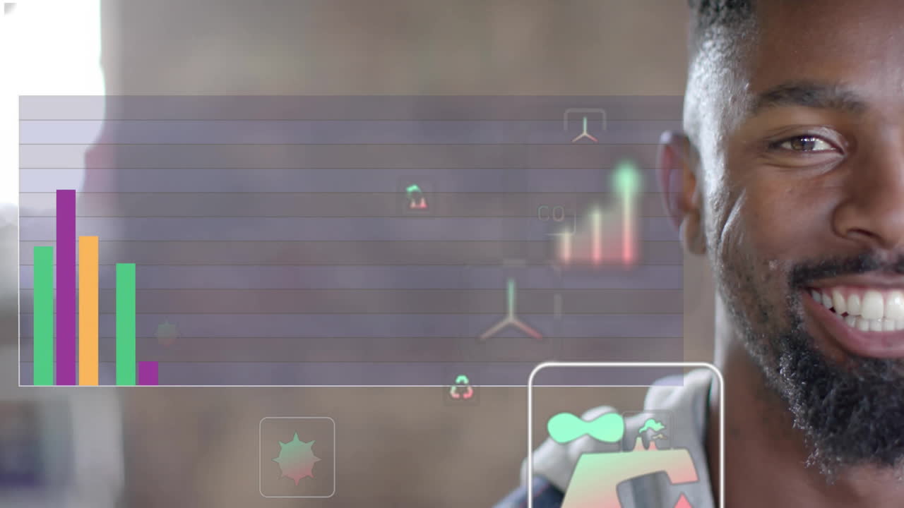 Animation of ecology icons and diagrams over biracial businessman smiling in office