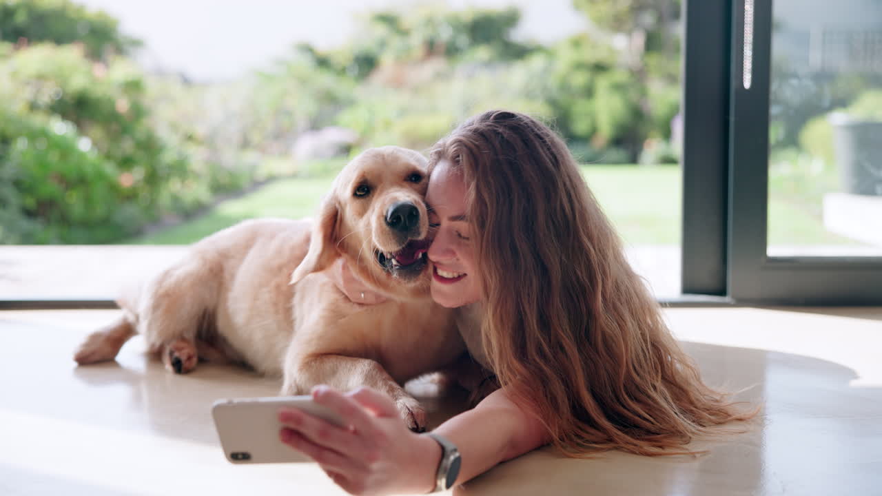 Woman taking a selfie with her golden retriever dog