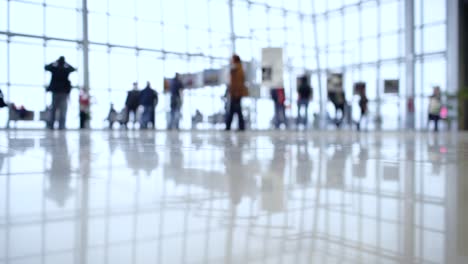 people walk inside a bright, modern building