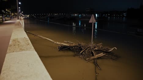 nighttime flood in city - river overflowing with debris