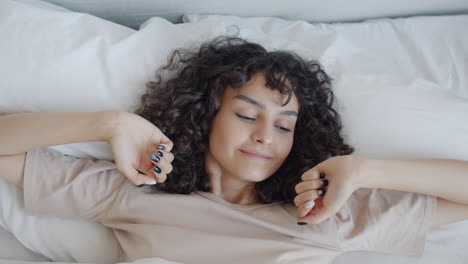 woman stretching in bed