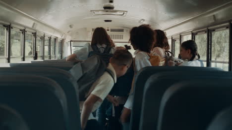 Energetic-pupils-leave-academic-shuttle.-Friendly-crowd-go-out-schoolbus.