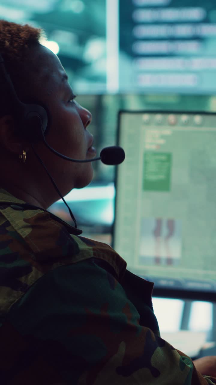 Woman in Military Uniform Operating Computer with Headset