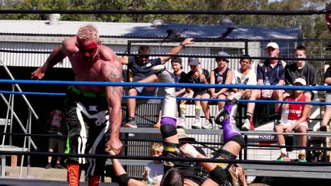 wrestlers compete in an outdoor wrestling ring