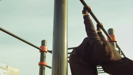 Man-Doing-Back-Lever-on-Pullup-Bar-at-Workout-Playground