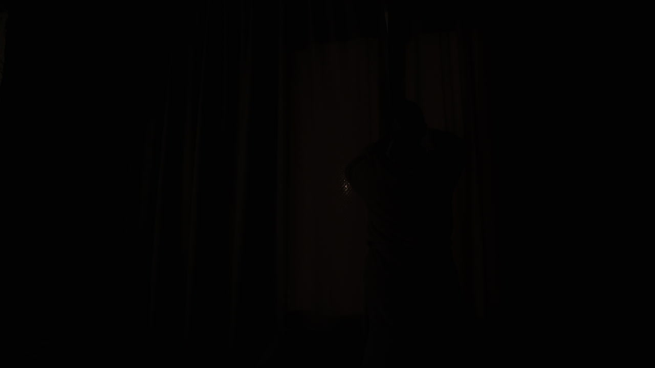 Woman opens curtains on window 1