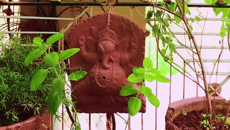 hindu god ganesha statue isolated at garden with tulsi tree for pray at day