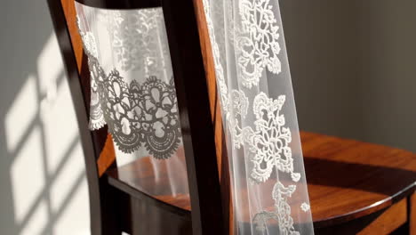 ornate wooden chair with lace back