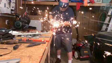 man welding in garage workshop slow motion