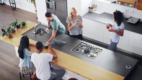 Overhead-View-Of-Friends-Drinking-Coffee-In-Modern-Kitchen