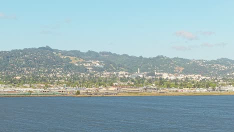 a quiet, wind-swept peninsula stretches into the bay as the drone floats from cesar chavez park.