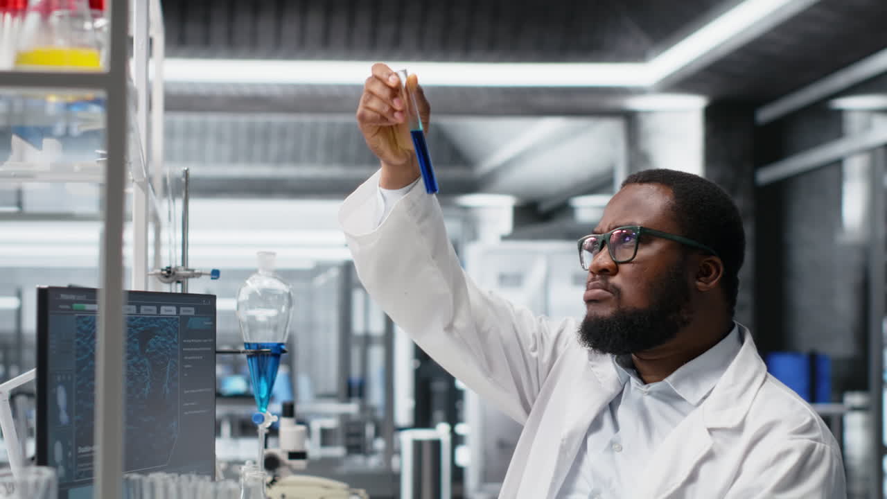 Vertical video Chemical engineer in lab inspecting chemical compounds using PC software