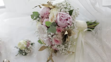 beautiful wedding bouquets lie near window on white curtains