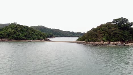 Hong-Kong-bay,-with-a-strip-of-sand-connecting-small-natural-islands,-Aerial-view