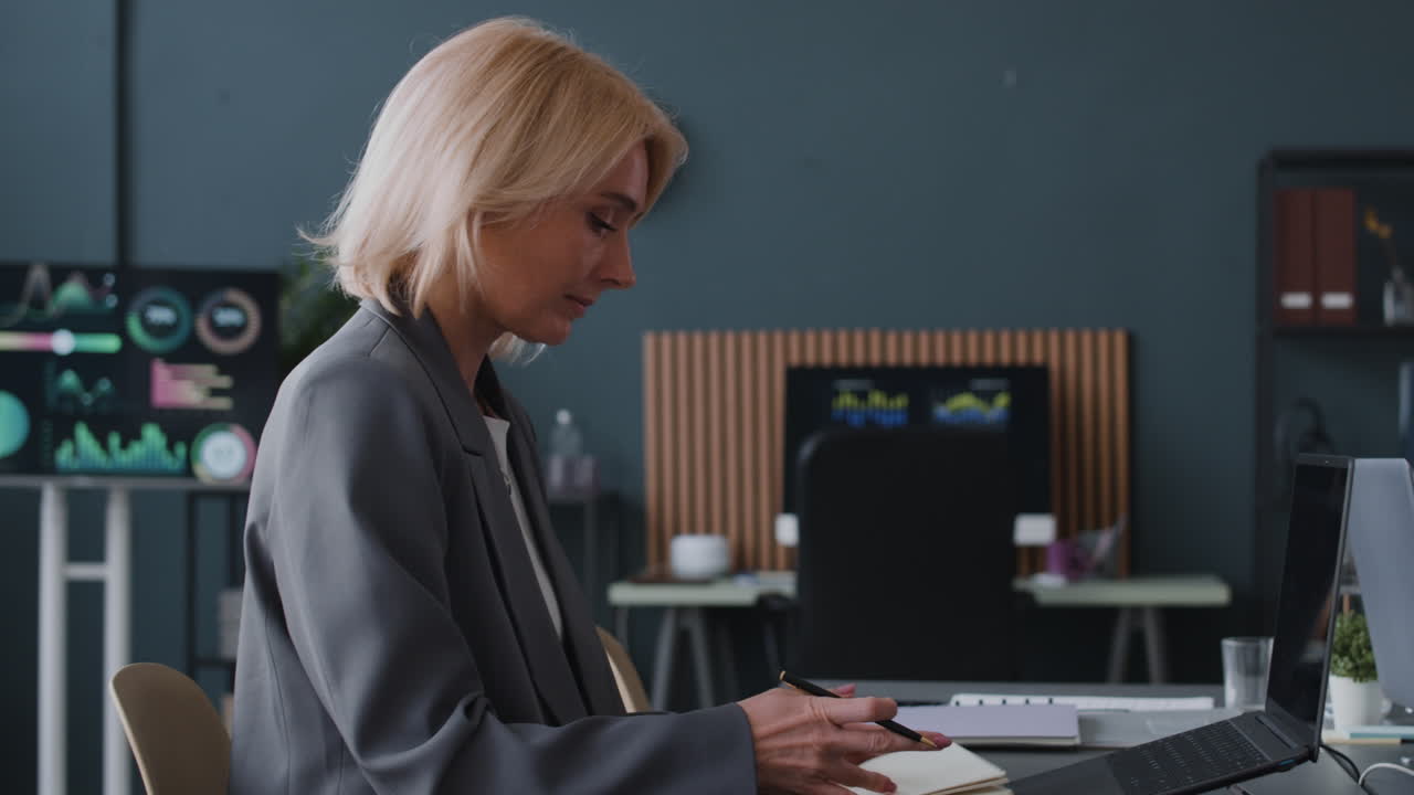 Businesswoman Taking Notes in Modern Office