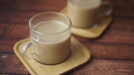 two cups of hot drink on a wooden table