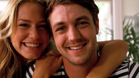 Smiling-couple-embracing-in-the-kitchen