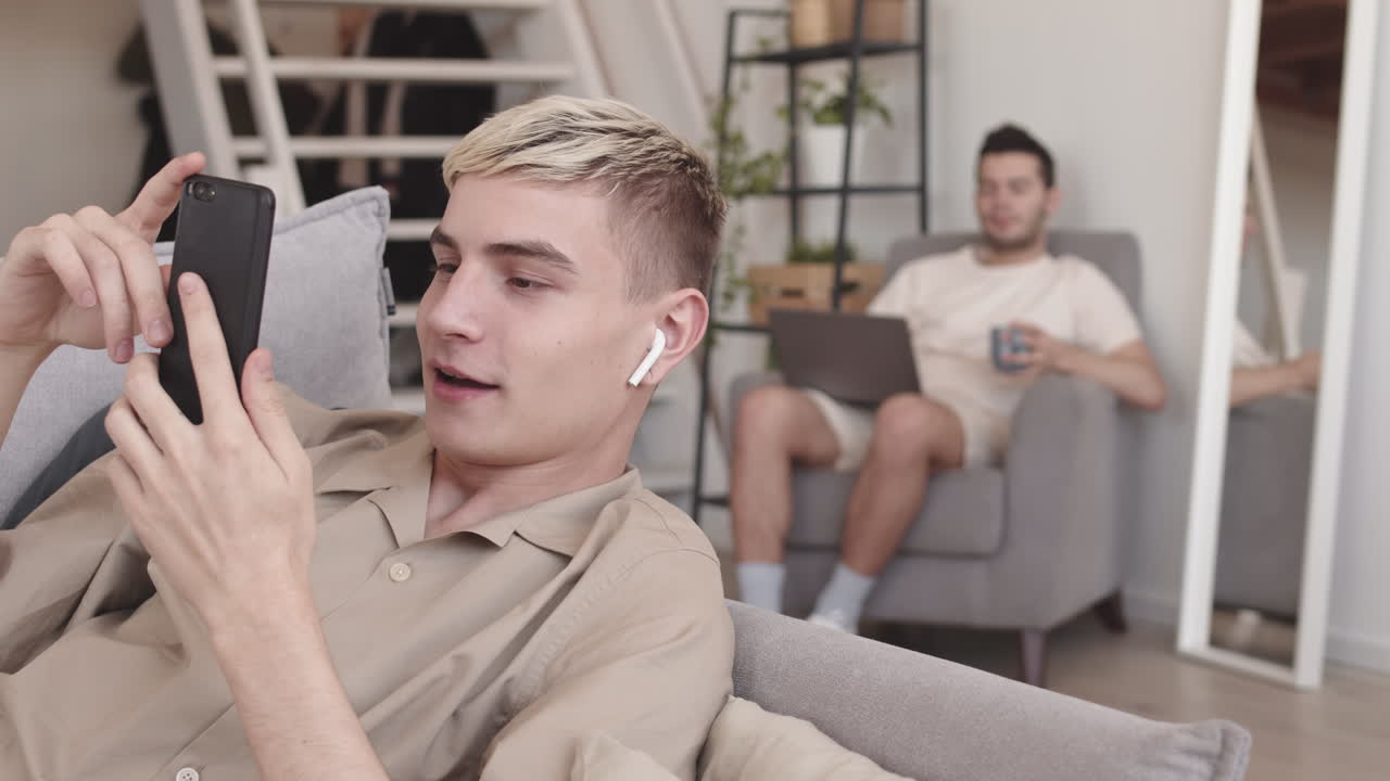 Blond-haired Young Man Having Video at Home