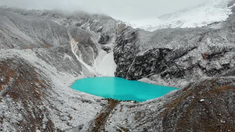 bright blue lagoon 69, aerial, in the midst of the snowy mountains and glaciers, peru, south america