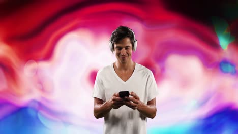 Animation-of-caucasian-man-with-smartphone-and-headphones-over-colorful-background