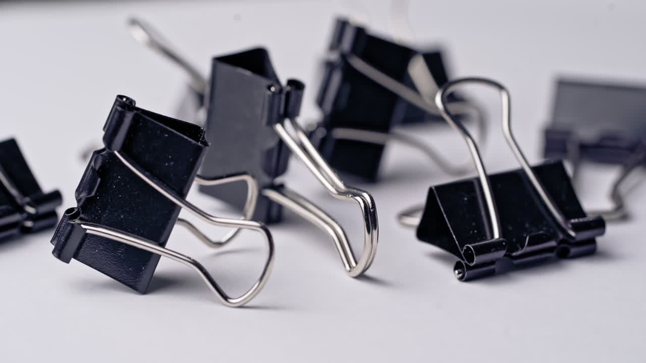 Pile of metal binder clips. Office supplies