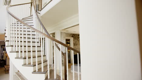elegant spiral staircase with wooden handrail in modern, luxurious home interior, copy space