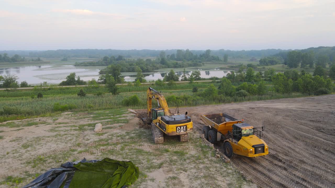 Construction equipment at a landfill getting dirt to cover the garbage, Michigan, USA