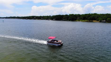 pontoon boat cruising through the sound past some small islands near destin florida