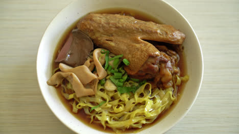 egg noodles with stewed and braised duck in brown soup - asian food style-2