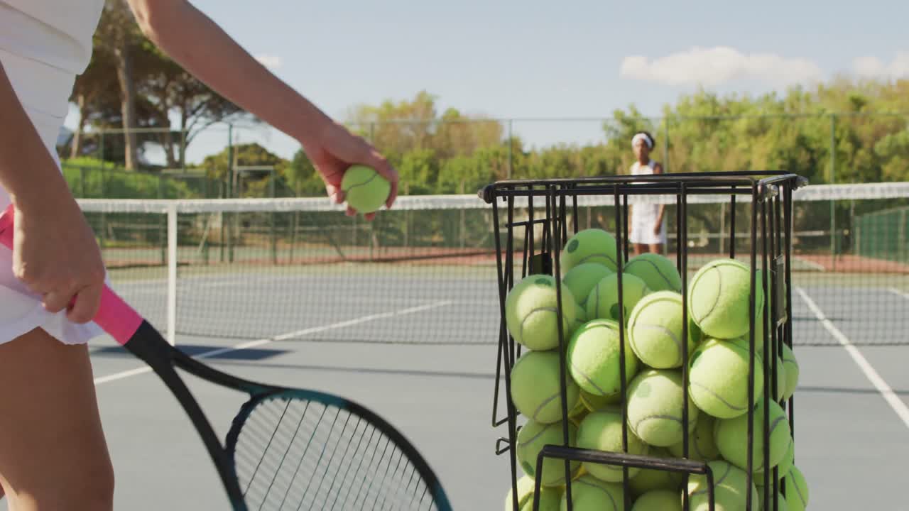 Video of basket with tennis balls on tennis court