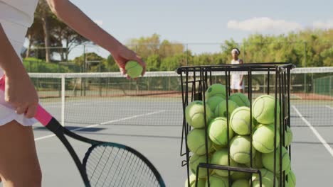 video of basket with tennis balls on tennis court