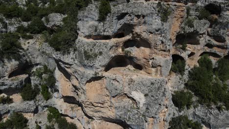 Drone-view-of-the-rocks-on-the-mountain-eroded-and-turned-into-caves,-image-of-rocks