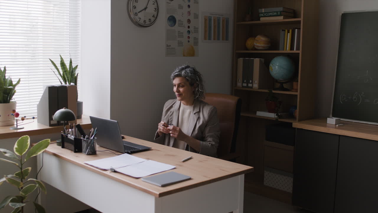 Teacher Conducting an Online Lesson in a Classroom