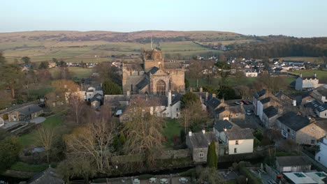 Slow-Motion-clip-of-the-Cumbrian-medieval-village-of-Cartmel-showing-the-historic-Cartmel-Priory-at-sunset-on-a-winters-day