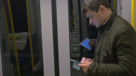 commuter with pad in underground train