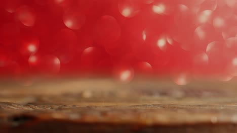 christmas valentine's day red defocused bokeh background wooden desk foreground