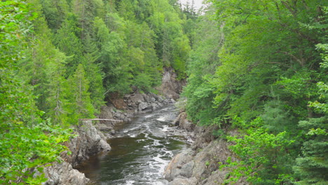 tighter shot of the batchawana river flowing through the rocky forest of ontario on it's way to lake superior